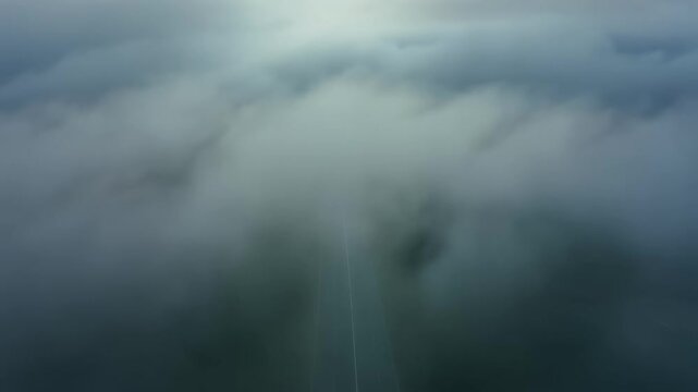 Aerial misty clouds drift over hidden mountain ridges.
