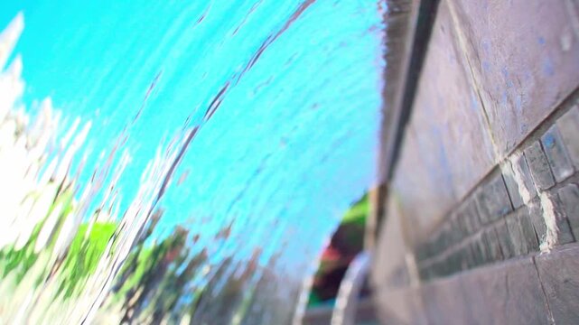 A slow-motion view of a scupper waterfall