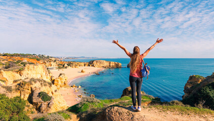 Happy female tourist exploring Algarve coast and beach in Portugal © M.studio
