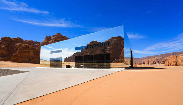 The Maraya mirrored concert hall reflecting the ancient desert mountains of Ashar Valley in AlUla, Saudi Arabia