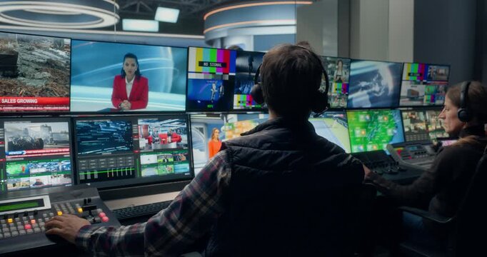 Backstage TV Station Production Control Room Operators Manage a Live News Broadcast, Switching Studio Feeds, Monitoring Industrial, Business News  Coordinating Channel Output Across Monitors