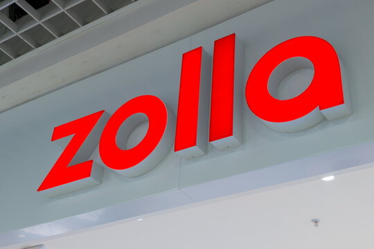 Zolla store sign located in shopping mall displays bright red lettering during daylight hours
