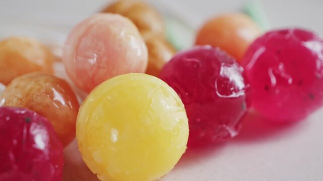 Bright colorful candies, lollipops on a white background rotating close-up.