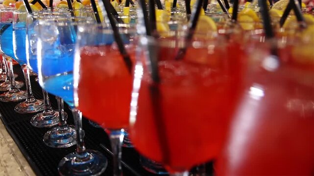 Colorful cocktails on a bar counter lined up ready to be served at a party, mixing vibrant ingredients to create a refreshing drink that adds energy, fun, and great vibes to the celebration