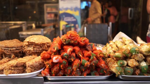 Indian street food stall with fried chicken snacks and rolls in Mumbai marketplace
