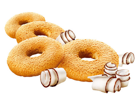 Coconut donut-shaped cookies with fresh coconut flakes, set aside on a transparent background