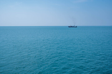 Fototapeta premium Ship sailing vast ocean on calm clear day