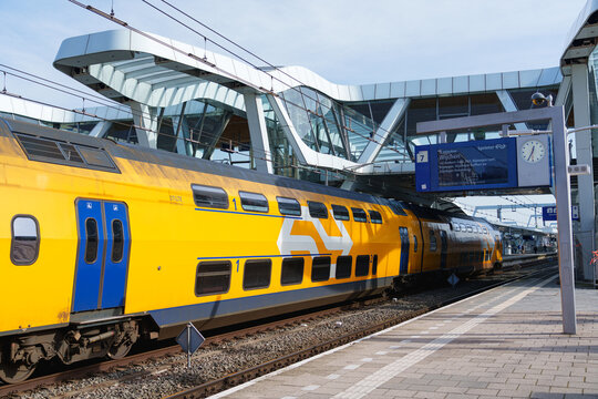 Arnhem, Netherlands - February 26 2026: Nederlandse Spoorwegen NS yellow double deck train at Arnhem Centraal station Netherlands