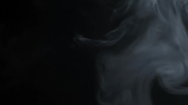 Smoke curls in the darkness