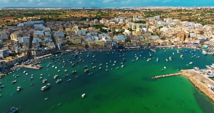 Aerial view of the Port of Marsaxlokk In Malta. A small fishing village with traditional colorful boats