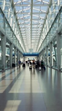 Busy Terminal: A Dynamic Journey Through a Modern Airport Hallway Filled With Passengers and Luggage Under a Bright Open Canopy