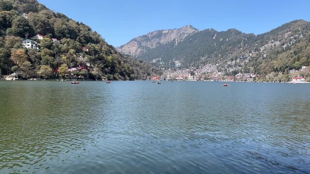 shot of Nainital Lake with boats in Nainital, Uttarakhand, India