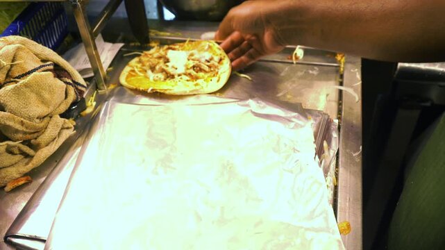 Preparing shawarma rolls at a street food stall in Mumbai city, India.