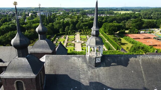Close aerial pass by Kamp Abbey clock tower and roof