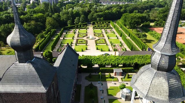 Fast aerial orbit revealing Kamp Abbey garden and village