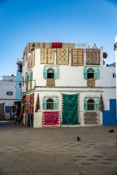 Colorful carpets hanging from a building in the medina, in Asilah, Morocco