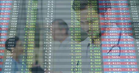 Naklejka premium Viewing three traders studying market data at office, with glass ticker and business attire