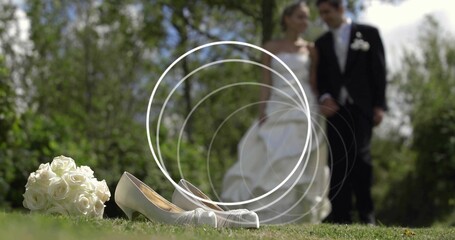 Vertical video: Camera filming shoes and roses as light making rings, wedding pair posing in attire