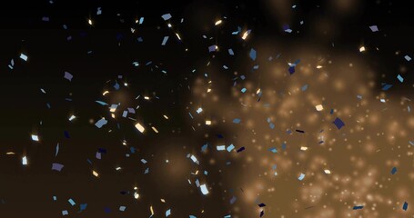 Falling rectangular confetti, metallic flakes and warm golden bokeh glowing over dark studio haze