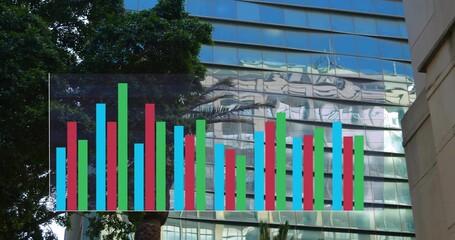 Naklejka premium Showing translucent bar chart overlay across glass facade at street, with palm and concrete wall