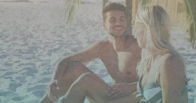 Man reaching forward and draping arm around woman on sunny beach, creating travel content
