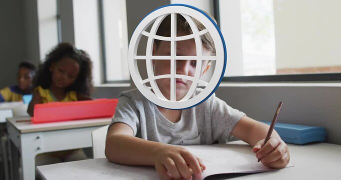 Boy at desk studying worksheet in classroom, globe overlay appearing marking problems while tracing