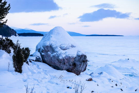 snowy memorial stone on coast of Kandalaksha Bay