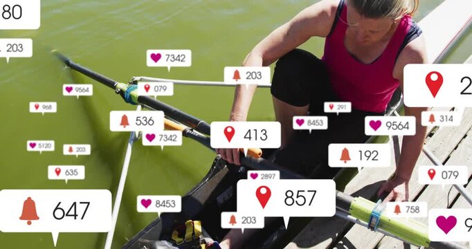 Vertical video: Notifications appearing, rower adjusting oar and feet, bracing dock, prepping boat