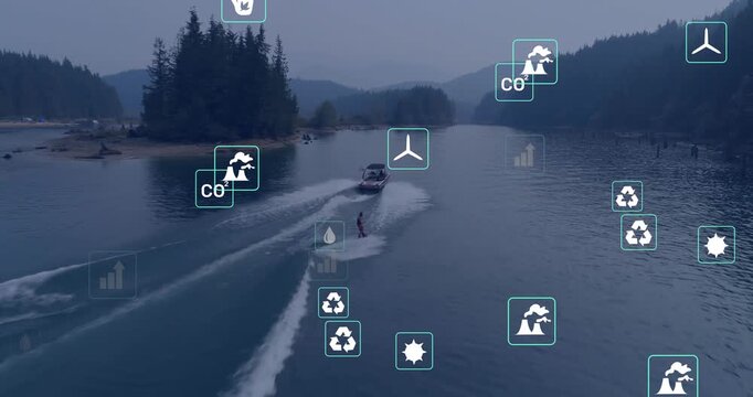 Vertical video: Boat leaving shore on lake towing rider in vest on wakeboard for fun with icons
