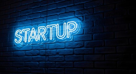 Fototapeta premium Blue neon startup sign on dark brick wall neon sign