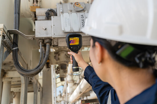 Engineer performs thermal scanning on substation equipment with an infrared camera, supporting safety checks, condition monitoring, diagnostics, reliability, and maintenance.