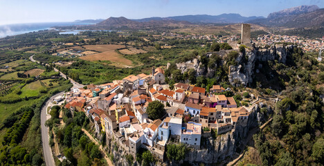 Posada Sardinia aerial view of colorful village on rocks with medieval castle Castello della Fava Italy, aerial drone view of scenic hilltop town landscape travel destination Sardegna