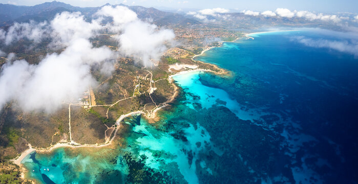 Sardinia Isuledda beach aerial drone view. Mediterranean Caribbean turquoise water  above the cloud passage. Scenic Costa Smeralda coastline travel Sardegna