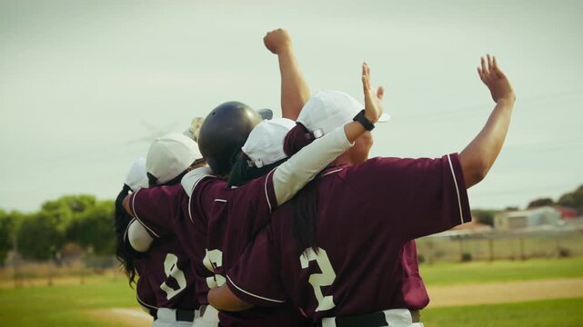 Baseball team celebrates victory with arms raised in triumph