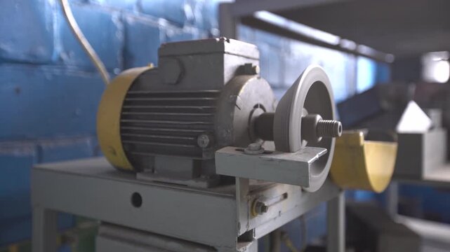 A grinding machine with a diamond wheel turns on and grinds metal. The machine produces a constant motor sound and light scraping noise as it works, showing the process in a workshop.