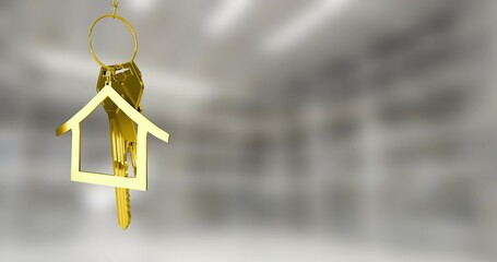 Hanging gold keys and house outline charm on circular metal keyring in entryway, copy space