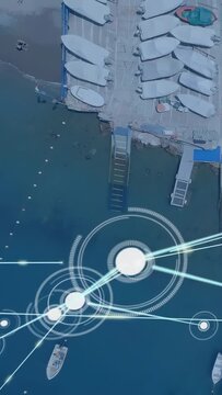 Pier storing dinghies showing bright circle launching glowing network across water for marine tech