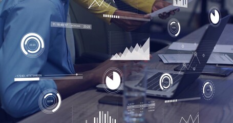 Working team wearing blue top and yellow sweater checking laptop data on wood table with overlays
