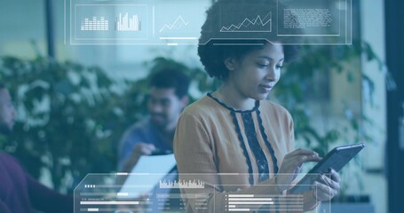 Interacting woman wearing tan blouse with black trim tapping tablet at office, with HUD overlays