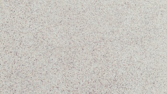 Beige washed stone gravel texture, polished pebble floor surface background.