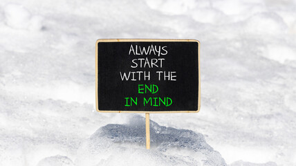 Start with the end in mind symbol. Concept words Always start with the end in mind on beautiful black blackboard. Beautiful snow background. Business start with the end in mind concept. Copy space. © Dzmitry