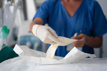 Healthcare professional preparing sterile gloves for medical procedure