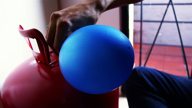 Man Inflating Blue Balloon With Helium Tank, Preparing Decoration For Birthday Party - 4K