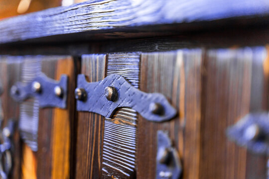A wooden door with a black metal latch