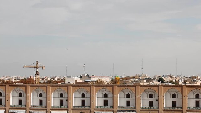 Panoramic aerial view of the Old City of Isfahan, Iran, with historic mosques and dense rooftops visible across the urban landscape as a sandstorm approaches the city. Dramatic desert dust storm 
