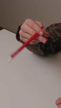 Nervously shaking a pen before dropping it.
