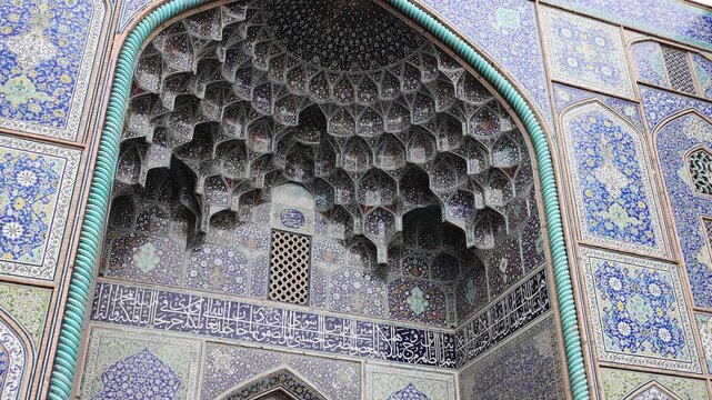Decorated ceiling of the Imam Mosque with intricate blue tile patterns and geometric ornament. Persian Islamic architecture inside Imam Mosque at Naqsh-e Jahan Square, Isfahan, Iran, showing detailed 