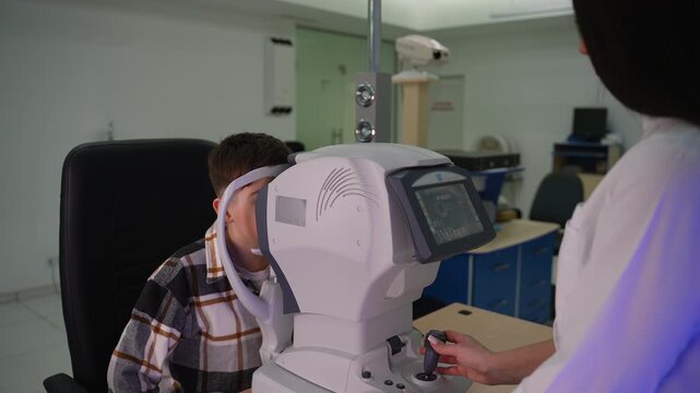 Ophthalmologist checking patient's vision with autorefractor machine