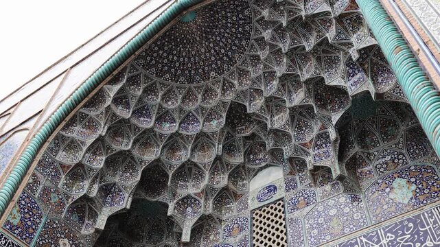 Decorated ceiling of the Imam Mosque with intricate blue tile patterns and geometric ornament. Persian Islamic architecture inside Imam Mosque at Naqsh-e Jahan Square, Isfahan, Iran, showing detailed 