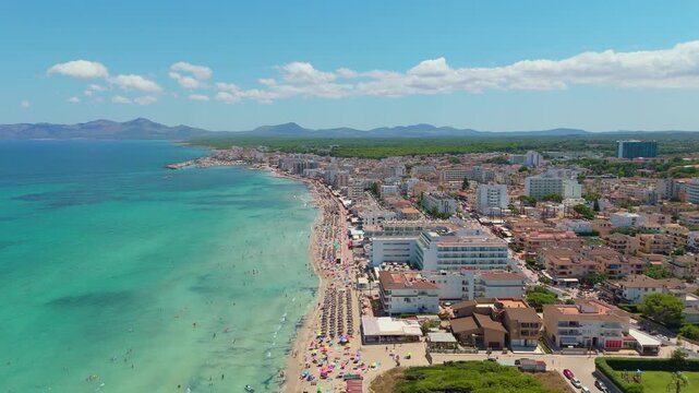 Drone aerial view of Can Picafort beach town and turquoise Mediterranean sea Mallorca Spain